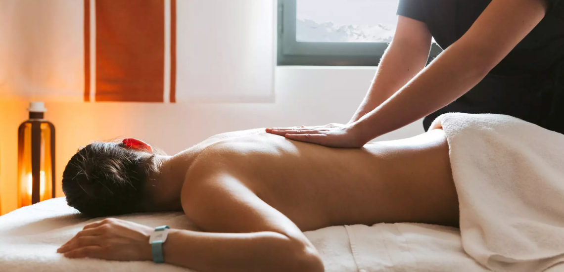 Club Med La Plagne 2100, France - Image d'une femme couchée sur une table de massage, profitant du soin qu'elle reçoit 