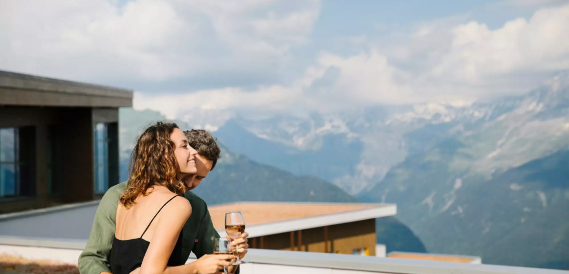 Club Med Samoëns, en France - Image d'un couple au coucher de soleil qui s'offre un verre de vin, au Skyline.